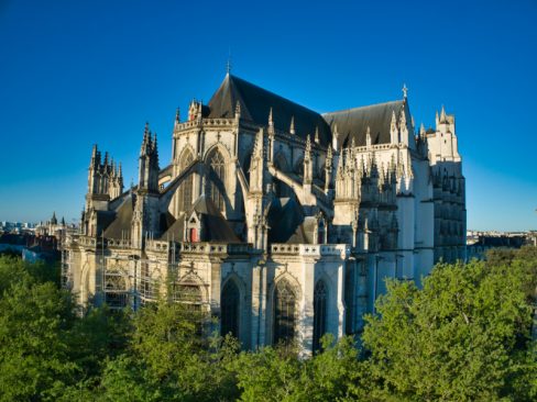Dans l'au-delà, s'élevant du sol, au dessus des arbres du cours St Pierre, la cathédrale Saint Pierre et Saint Paul de Nantes s'élève vers les cieux.