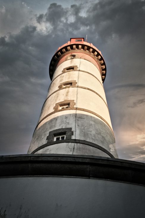 Depuis le pied du phare de la pointe Saint Mathieu au nord de Brest, on admire la majesté de ce guide. Le soleil se couche dans le Finistère et le phare semble prendre un dernier bain de soleil avant de retourner signaler la présence de récifs, et de la côte aux navires croisant au large.