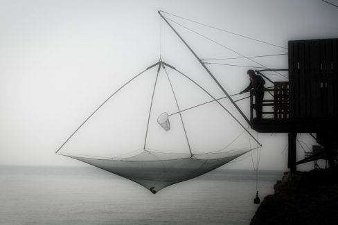 Une pêcherie sur les bords de l'Atlantique, dans les environs de Pornic en Loire Atlantique. Un homme est en train de remonter son carrelet afin de ramasser ses bouquets de crevettes..